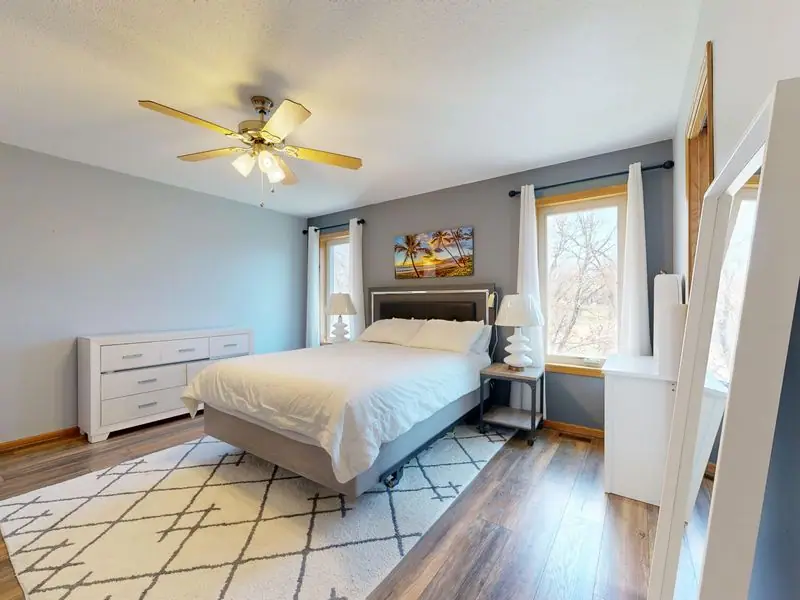 A bright bedroom with crisp white linens and sea light
